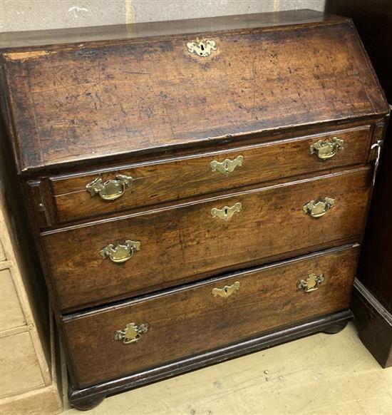 A mid 18th century oak bureau with well, width 92cm, depth 46cm, height 99cm